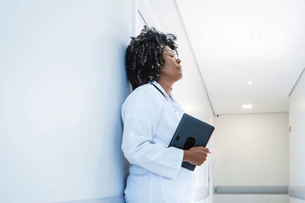 A person in a white coat holding a tablet
AI-generated content may be incorrect.